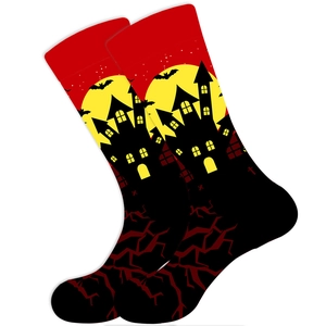 Detail of Halloween socks with bats, full moon and castle patterns on red and black base