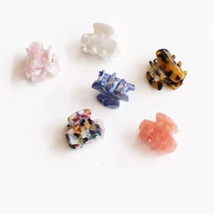 Set of 6 mini acetate hair claws with various marble and leopard patterns on white background