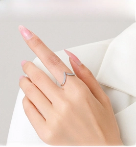Macro view of V-shaped S925 sterling silver ring with pavé light blue cubic zirconia