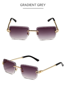 Detail of gradient grey rimless sunglasses with twisted gold metal temples and carved edges