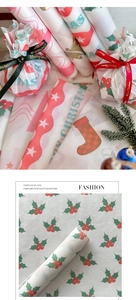 Détail de papier de soie de Noël avec motifs festifs et rubans Joyeux Noël