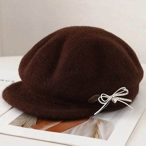 Deep brown wool beret hat with a polka dot bow and metallic heart charm detail