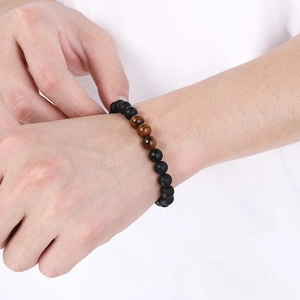 Men's matte black onyx beaded bracelet with tiger eye stones on an elastic cord