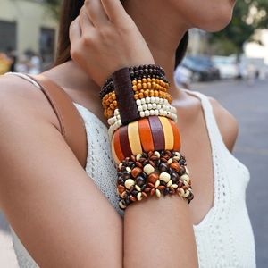Bohemian multi-layer wooden bead bracelet set with round and geometric beads on wrist