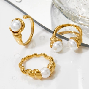 Minimalist gold plated stainless steel shell pearl ring set displayed with water drops