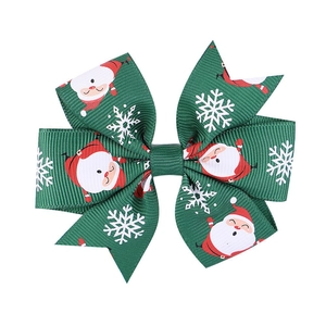 Christmas hair bow clip featuring green cartoon Santa Claus and snowflake patterns