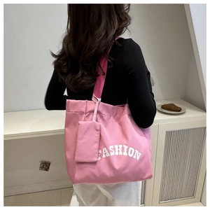 Rear view of a pink canvas tote bag with Fashion lettering and matching mini pouch