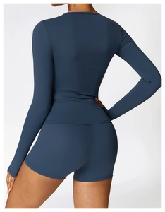 Rear view of tight brushed long-sleeve yoga top and high-waisted shorts in dark teal