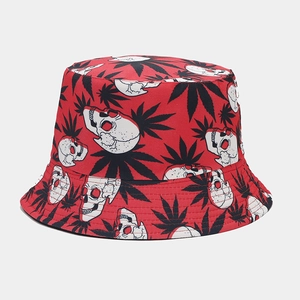 Detail of red bucket hat featuring black leaf and white skull pattern prints
