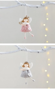Close-up of pink and grey felt angel ornaments with soft fabric texture and hanging ropes