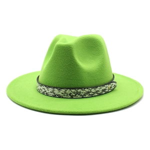 Detail of neon green fedora hat featuring snake print band and golden rivet accent
