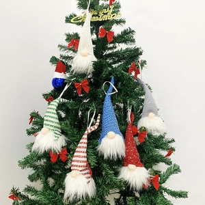 Knitted Christmas gnome ornaments set hanging on a small tree for home decor