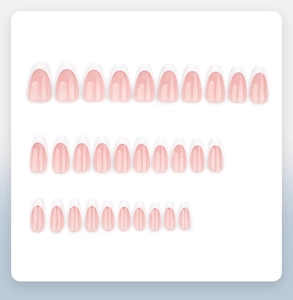 Flat lay of 30 pieces light pink French almond press-on nails with white tips display