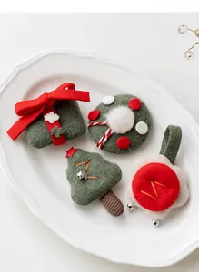 Detailed view of handmade Christmas felt accessories including wreaths and trees