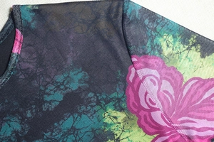 Detail of round neckline and floral print on breathable black mesh fabric dress