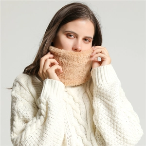 Close-up of soft camel plush neck warmer scarf worn with a white knitted sweater
