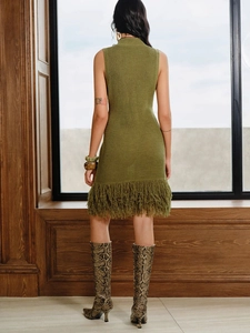 Olive green sleeveless knit dress with fringe hem shown in a stylish indoor setting
