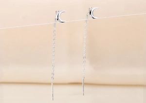 Close-up of S925 silver crescent moon tassel ear threader with delicate long chain design