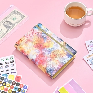 Close-up of mandala leather A6 binder with budget sheets and category stickers for finances