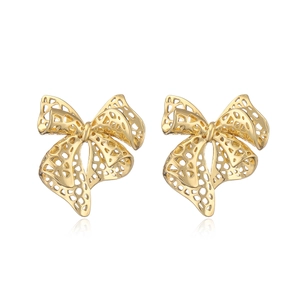Fashionable 18k gold plated hollow mesh bow stud earrings for women on white background