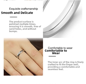 Detail of smooth polished steel ring with inner arc design and sparkling zircon stone