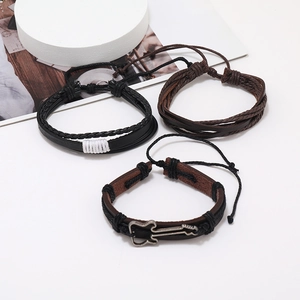 Detailed close-up of a three-piece leather bracelet set featuring a silver guitar charm