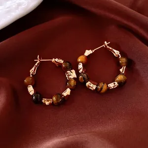Vintage 18k gold plated hoop earrings featuring tiger eye beads on dark silk background