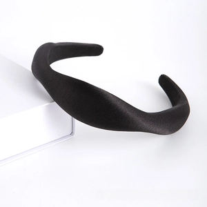 Macro detail of black padded headband showing textured fabric and thick sponge design