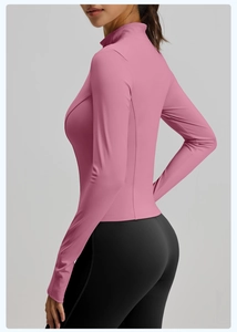 Detail view of pink yoga jacket sleeve with thumbhole and elastic quick-dry fabric