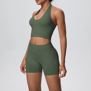 Detail of dark green ribbed seamless yoga set showing racerback top and high waist shorts