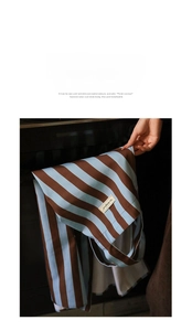 Detail of Nordic striped apron showing wrinkle-resistant fabric and premium leather label