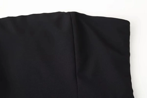 Detail of the high-quality stitching and plain weave black fabric on this elegant dress