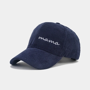 Detail of mama embroidery on navy blue corduroy baseball cap with high texture