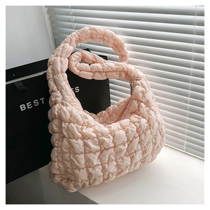 Pink quilted bubble puff shoulder bag with textured pattern and soft strap