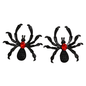 Close-up of gothic spider earrings featuring a red crystal gem in black metal setting