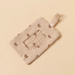 Close-up of beige cotton crib hanging bag featuring rainbow prints and zipper closure