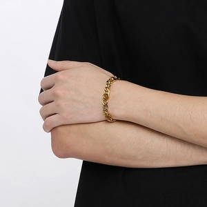 Gold-plated Cuban link bracelet for men and women featuring inlaid brown gemstones on wrist