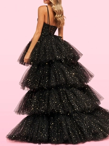 Detailed back view of layered black tulle evening gown with gold star sequins and lace-up back