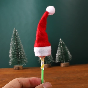 Close-up of mini red felt Santa hat decorating a lollipop stick