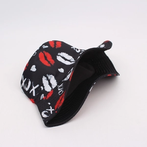 Close-up of black bucket hat with red lip prints and XOXO pattern details