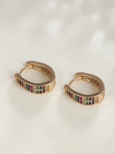 Detailed macro shot of 18K gold hoop earrings with multi-color micro-pave gemstones