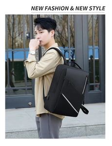 Detail view of black business laptop backpack showing the side USB charging port and zipper