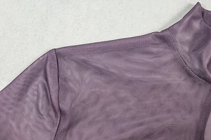 Detailed macro view of purple mesh fabric with fine diamond texture on the shoulder and collar