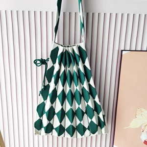 Detail of green and white checkered knitted handbag with pleated design and drawstring