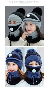 Close-up of thick knitted winter set with pom-pom hat, neck warmer, and breathable mask