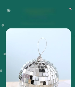 Close-up of sparkling silver disco mirror ball with small square glass tiles and silver loop
