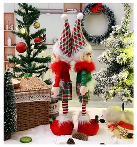 Detail of Christmas elf dolls with telescopic legs in red and green festive fabric