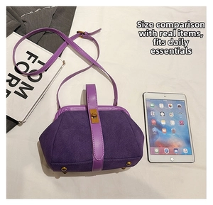 Detail view of vintage purple suede crossbody bag with metal feet and rotary clasp closure