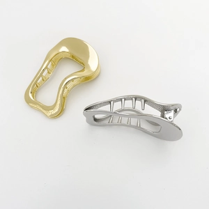 Irregular wave metal hair clips in gold and silver finish with textured grip