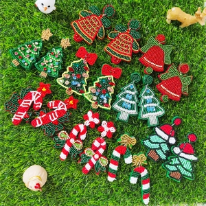 Handmade beaded Christmas earrings featuring festive tree, bell, and candy cane designs